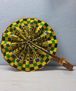 Kente Crown African Fan made from authentic 100% African wax cotton fabric, featuring a wooden handle, leather details, and a pattern inspired by traditional Kente fabric.