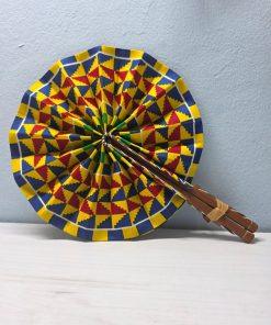 Kente Crown African Fan made from authentic 100% African wax cotton fabric, featuring a wooden handle, leather details, and a pattern inspired by traditional Kente fabric.
