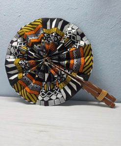 Bogolan Heritage African Fan made from authentic 100% African wax cotton fabric, featuring a pattern inspired by traditional Bogolan motifs, a wooden handle, and leather details.