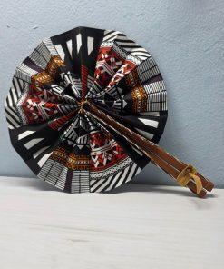 Bogolan Heritage African Fan made from authentic 100% African wax cotton fabric, featuring a pattern inspired by traditional Bogolan motifs, a wooden handle, and leather details.
