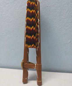 Ancestral Flame African Fan made from authentic 100% African wax cotton fabric, featuring a pattern inspired by flames and African symbols, a wooden handle, and leather details.