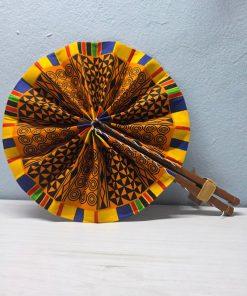 Ashanti Symbols African Fan made from authentic 100% African wax cotton fabric, featuring a pattern inspired by traditional Ashanti symbols, a wooden handle, and leather details.